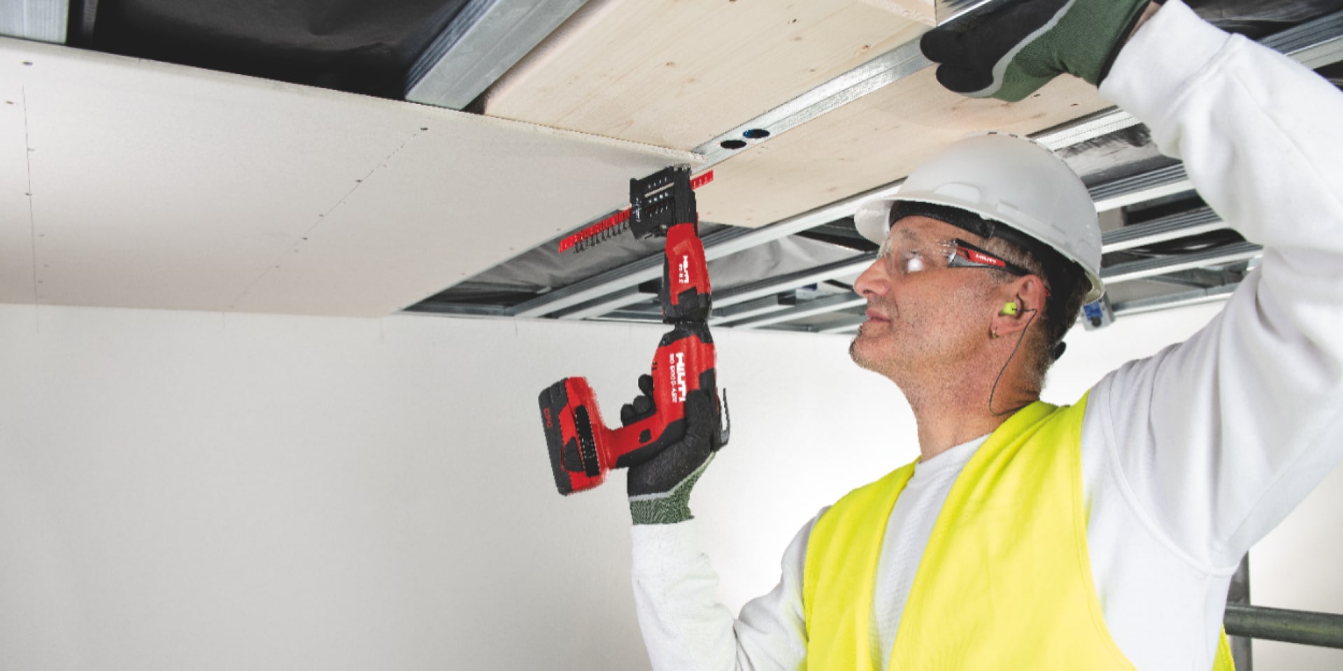 Image of drywall being installed overhead using collated screws, a screw magazine and the new SD 5000-A22 cordless drywall screwdriver